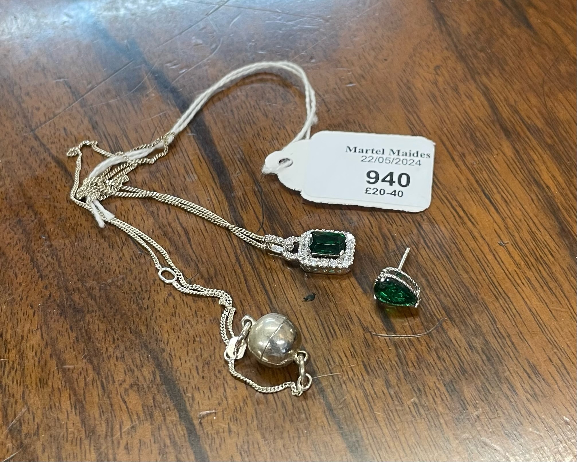 A sterling silver and green gem necklace and matching earrings