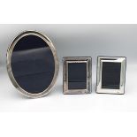 Three silver easel back photo frames