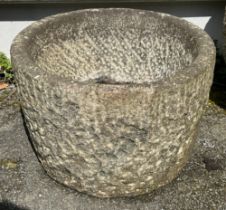 A granite cylindrical bird bath / planter or garden feature