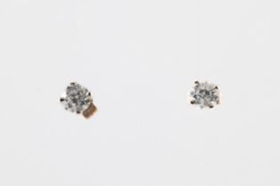 A pair of diamond stud gold earrings