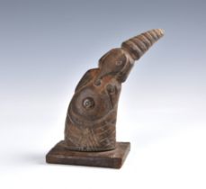 Tribal art - A carved horn figure of a dancer in an elephant mask