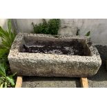 A rectangular granite trough