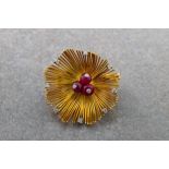 A Boucheron 18ct yellow gold, diamond and ruby flower head brooch