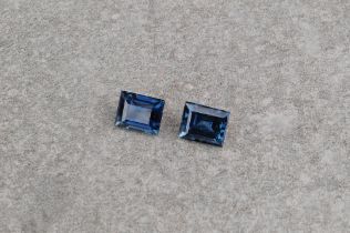 A pair of loose, baguette cut blue sapphires