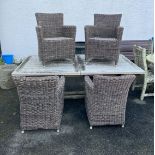 A set of four woven faux-rattan garden or conservatory armchairs