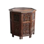 An Anglo-Indian style carved hardwood octagonal table/cupboard