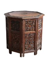 An Anglo-Indian style carved hardwood octagonal table/cupboard