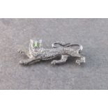 An 18ct white gold and diamond brooch in the form of a lion set with emerald eyes