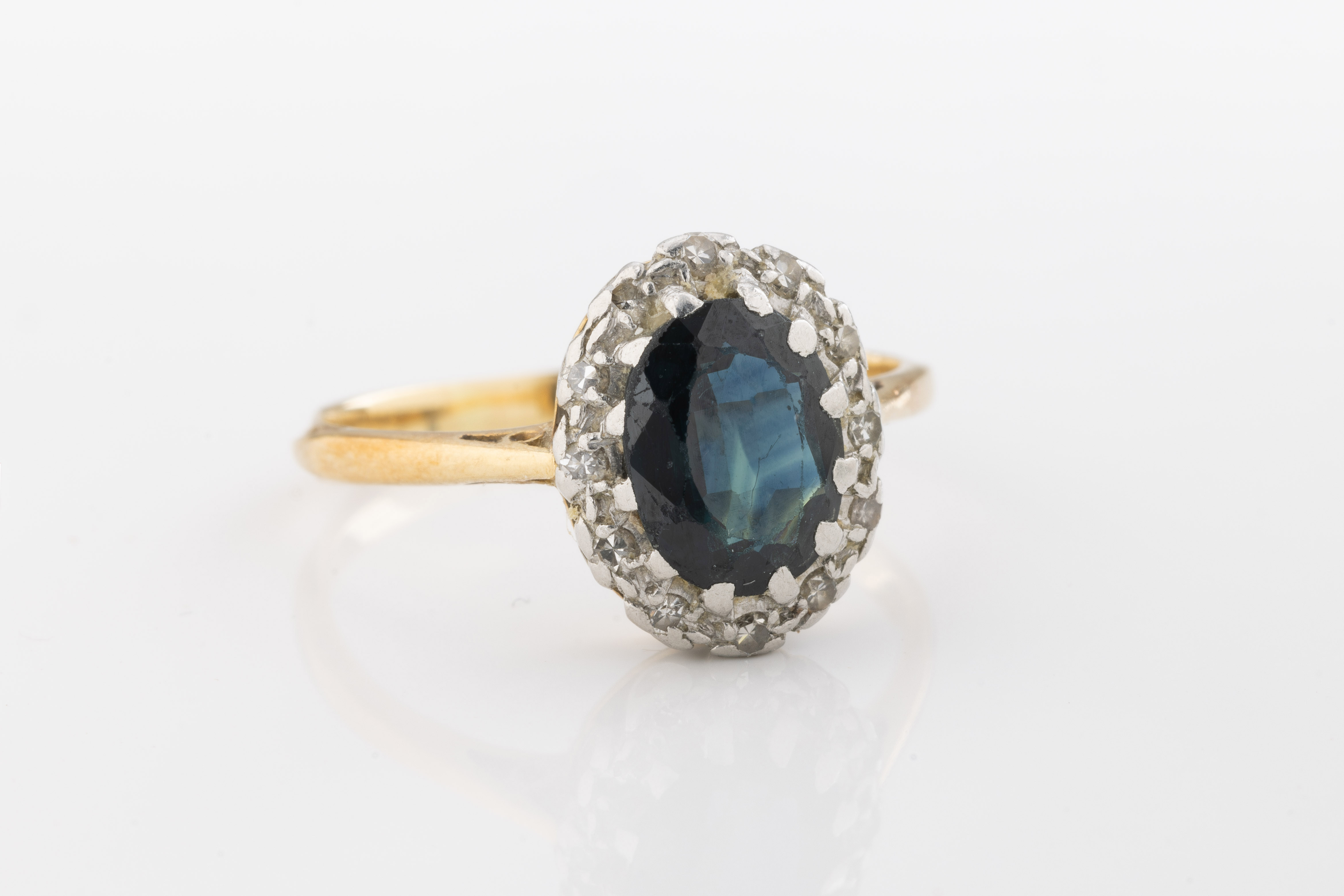 An 18ct yellow gold, sapphire and diamond cluster ring