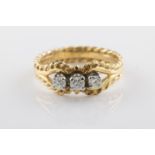 An 18ct yellow gold and diamond three stone ring