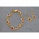 A 9ct yellow gold and garnet bracelet and matching earrings