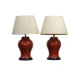 A pair of Chinese coral glazed baluster vases, converted to lamps.
