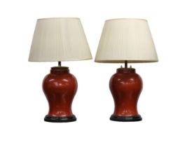 A pair of Chinese coral glazed baluster vases, converted to lamps.