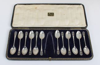 Twelve silver tea spoons and a pair of sugar tongs