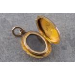 A Victorian 9 carat yellow gold hair locket