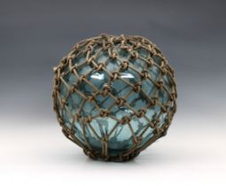 A large 19th century blown glass blue fishing float