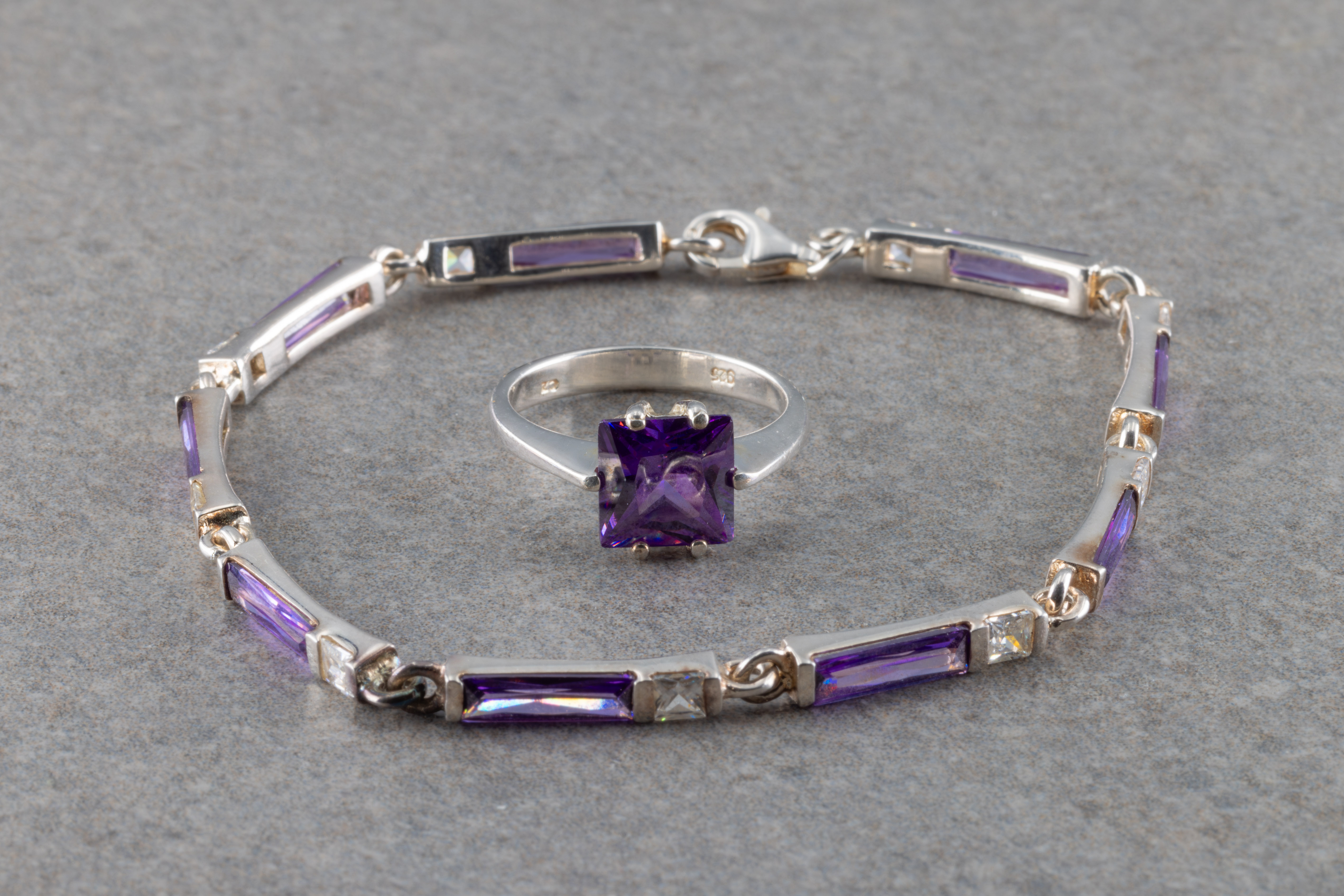 A sterling silver and amethyst solitaire ring and amethyst and zirconia bracelet