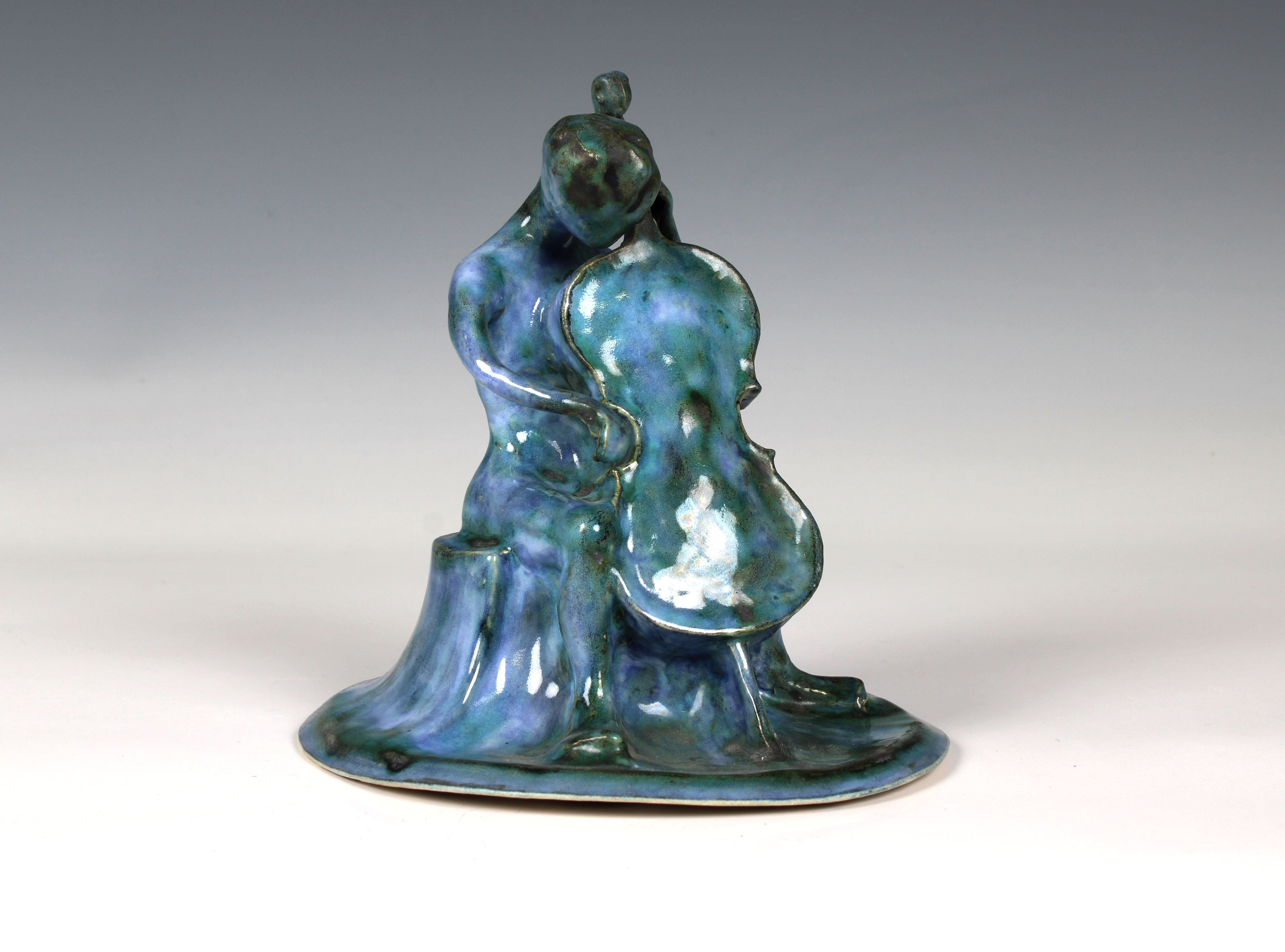 Elizabeth Ann Macphail (1939-89) A turquoise glazed stylised cellist or double bass player sculpture