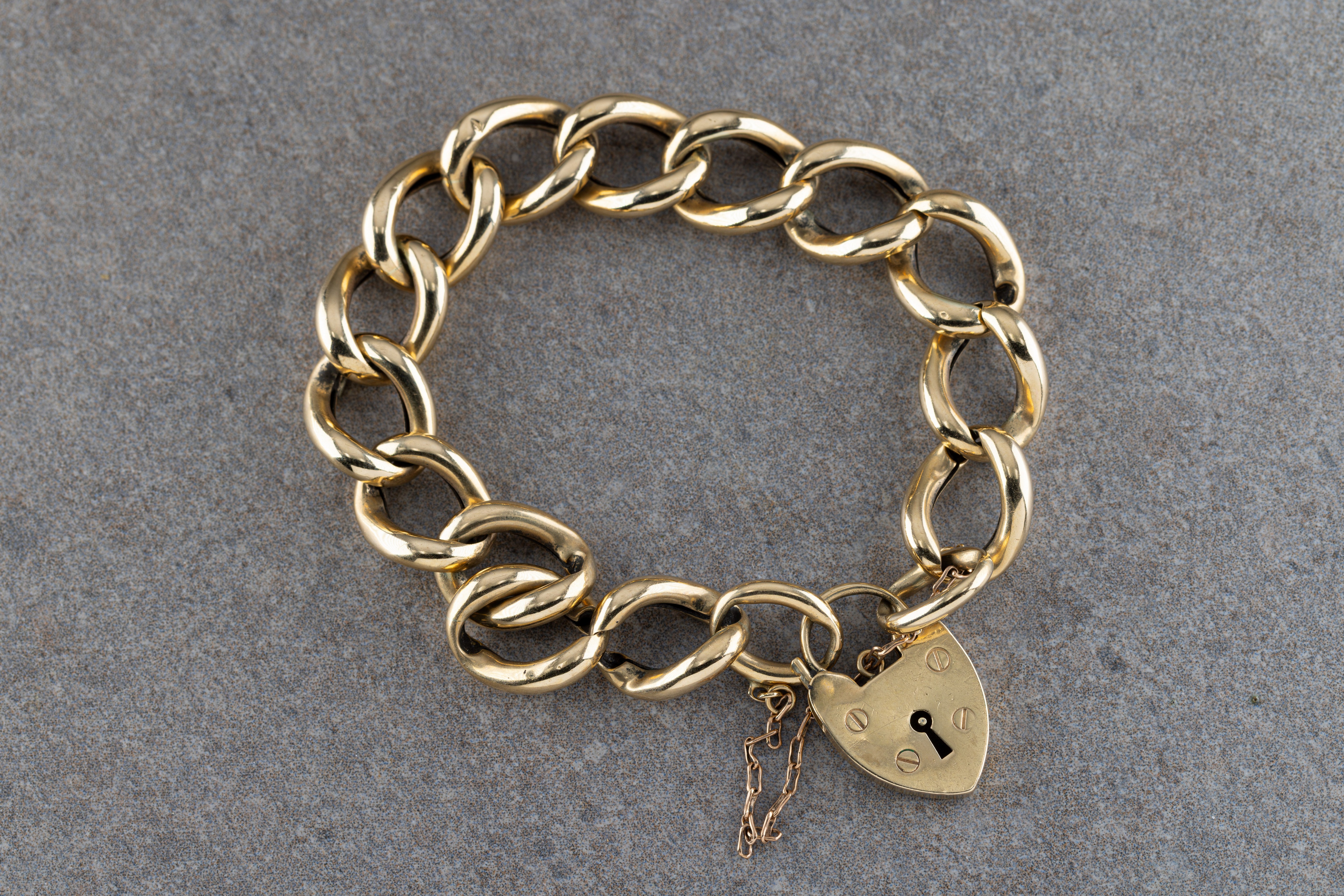 A 9ct yellow gold padlock and chain bracelet