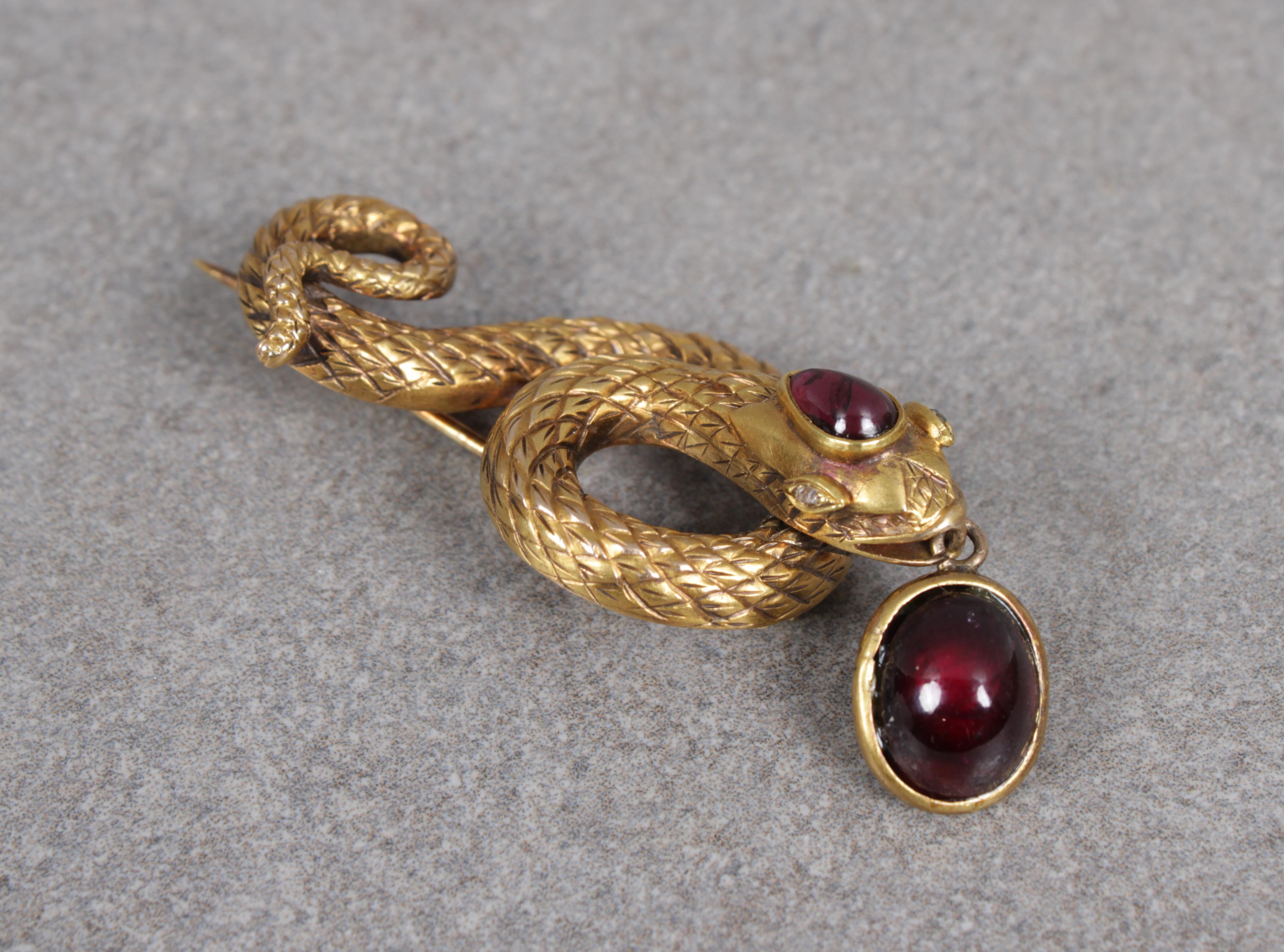 A gold serpent brooch