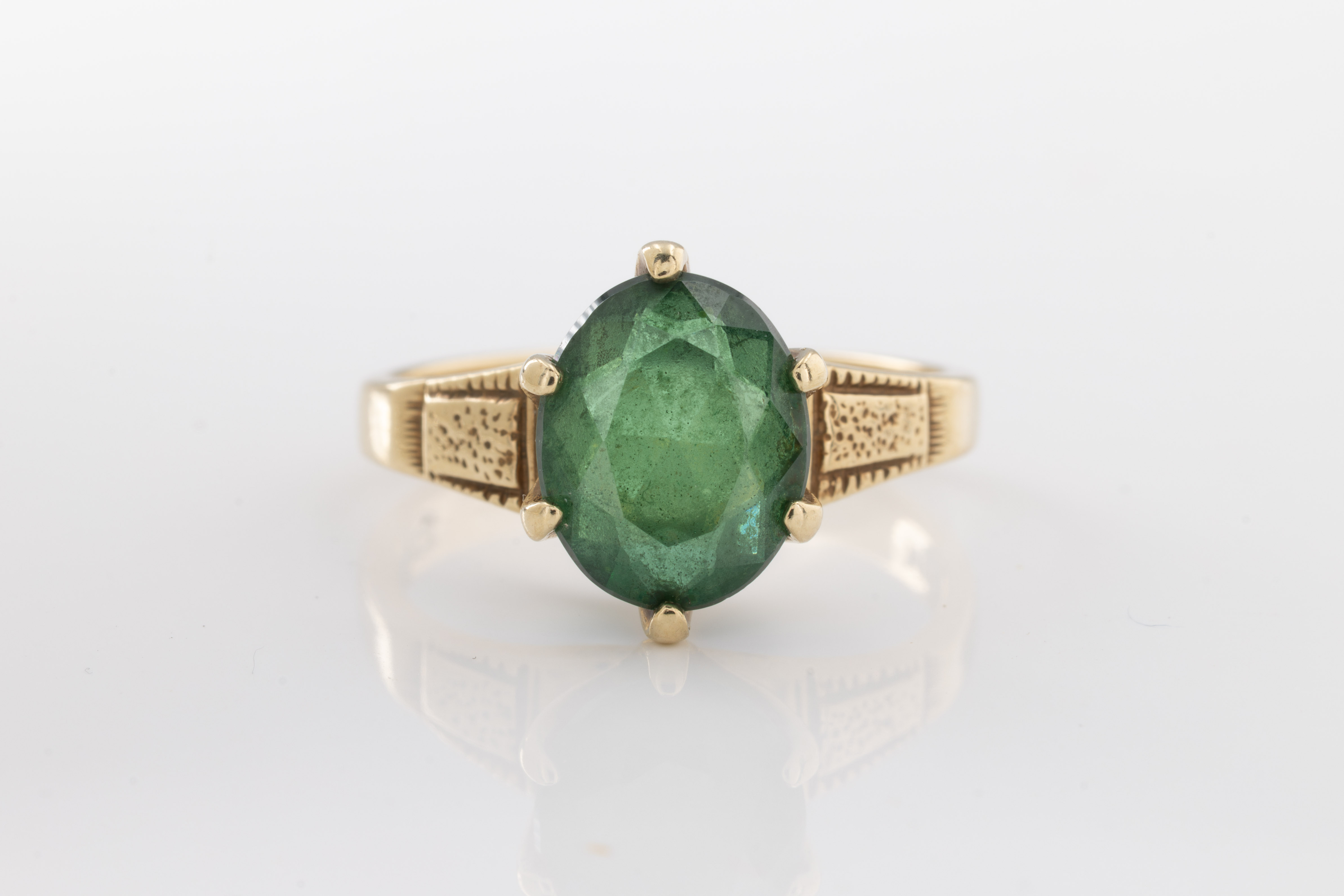 A green stone doublet ring