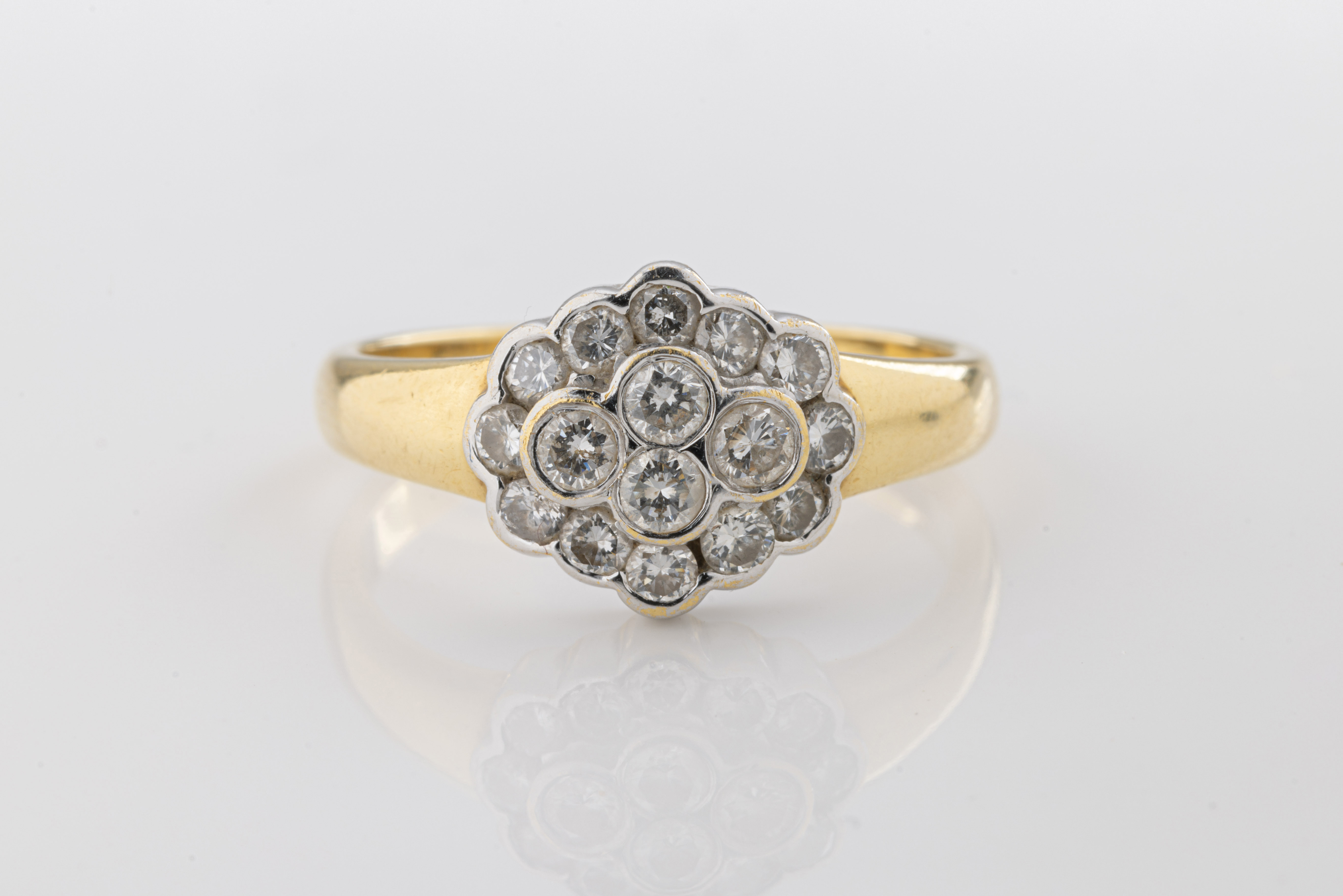 A yellow gold and diamond cluster ring