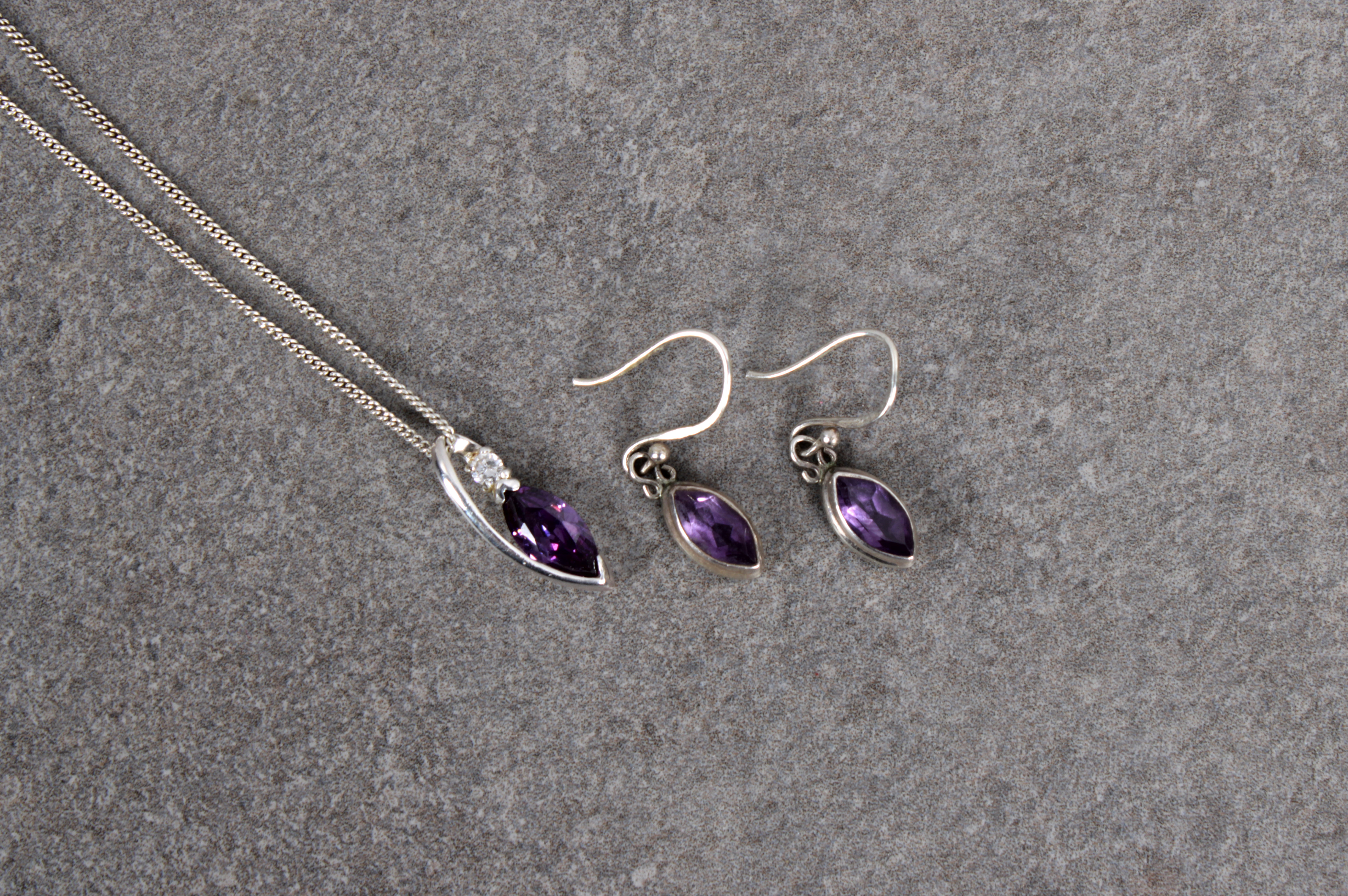 A sterling silver amethyst and CZ pendant necklace and matching earrings