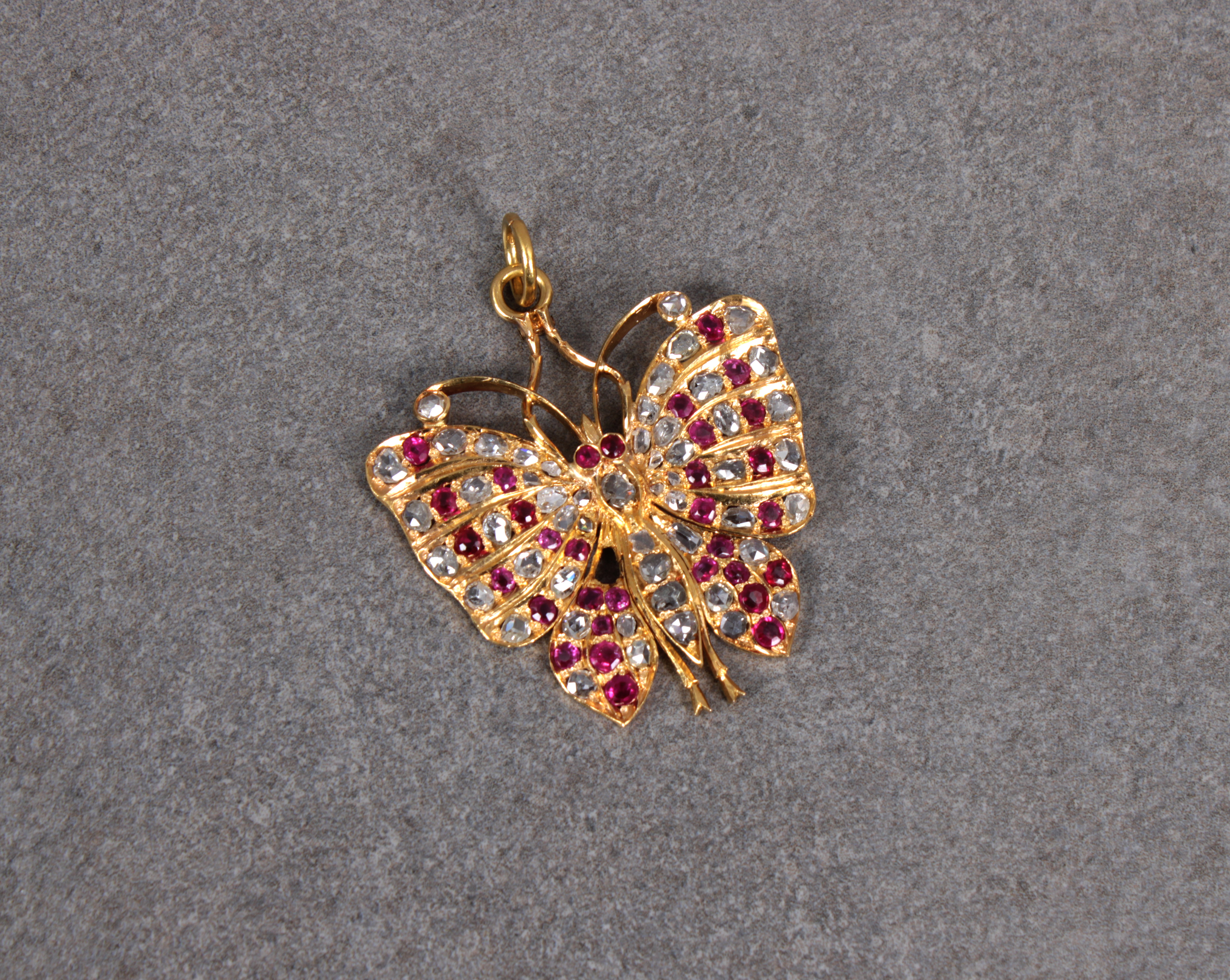 A diamond and ruby butterfly pendant
