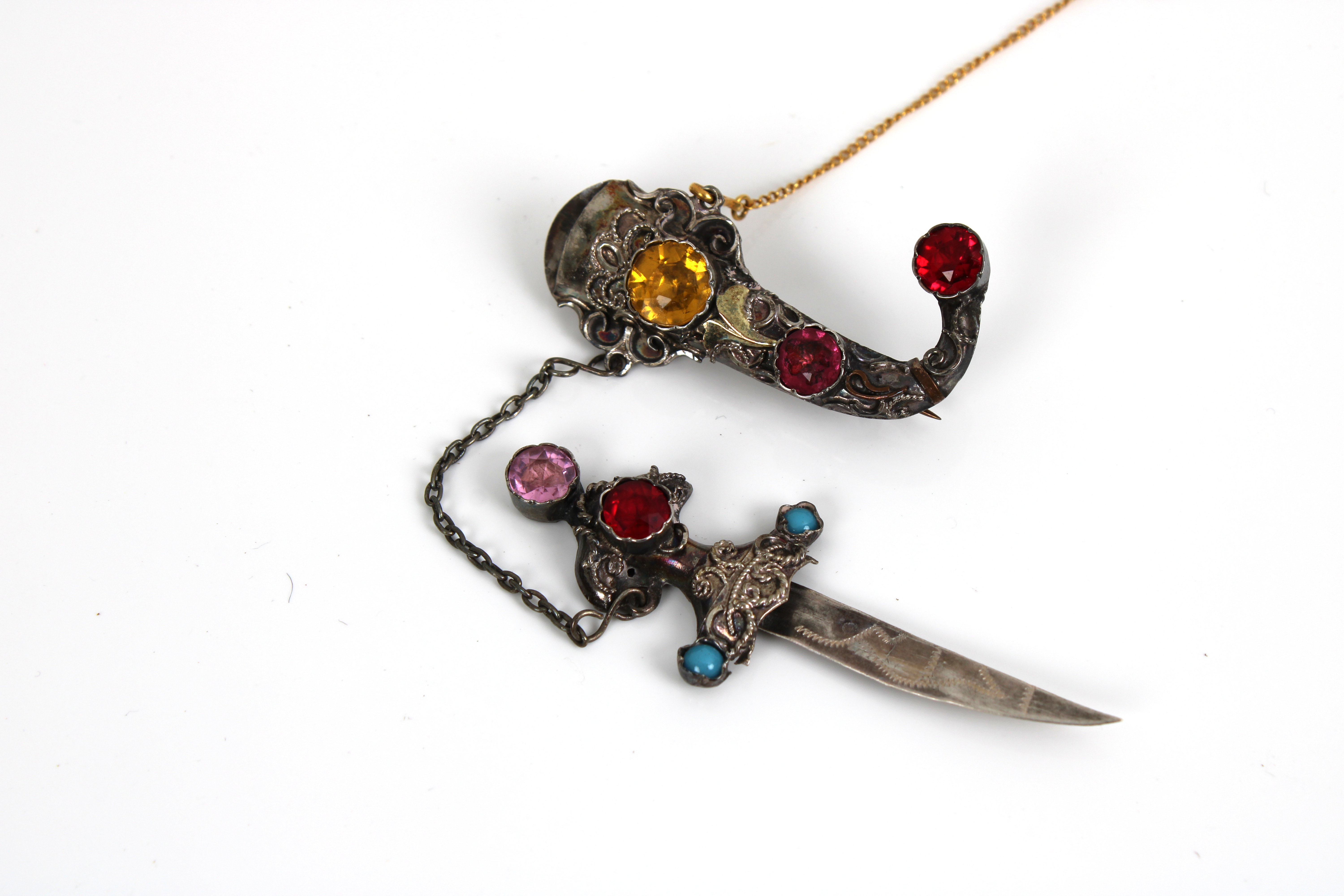 A silver filigree Berber dagger brooch set with semi precious stones