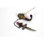 A silver filigree Berber dagger brooch set with semi precious stones