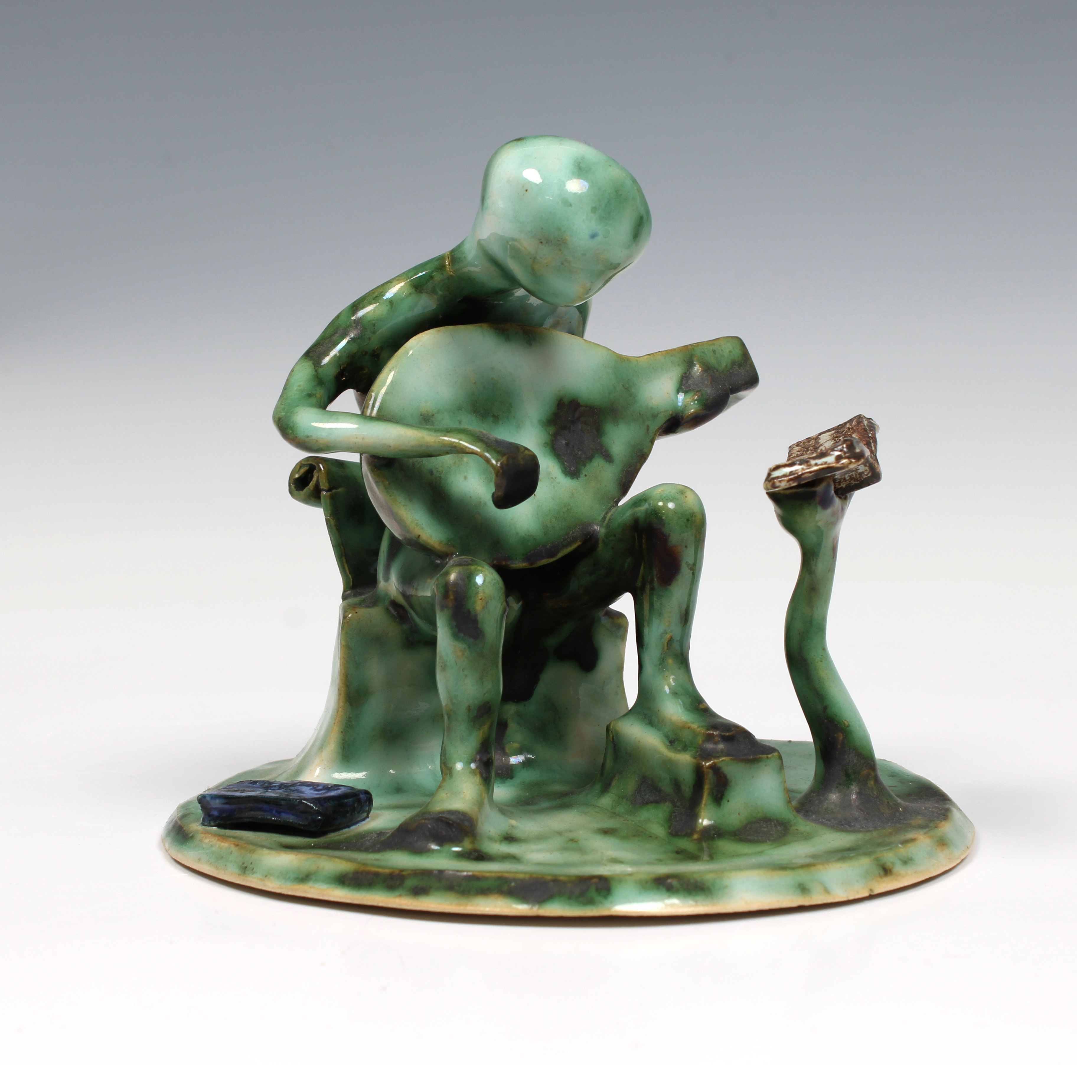 Elizabeth Ann Macphail (1939-89) A stylised green glaze lute player sculpture