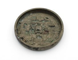 A Chinese bronze mirror profusely decorated to one side