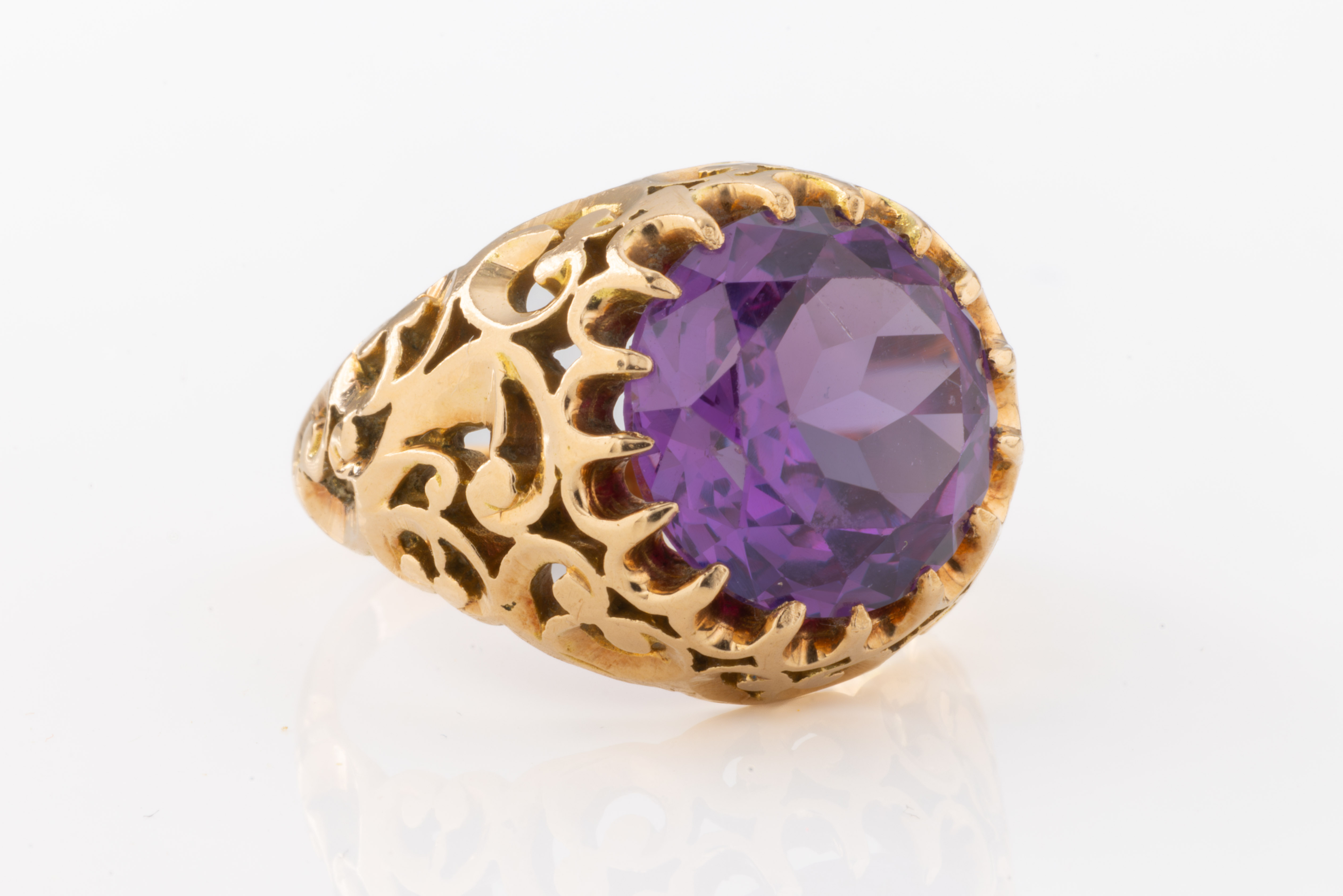 A gold and purple stone ring
