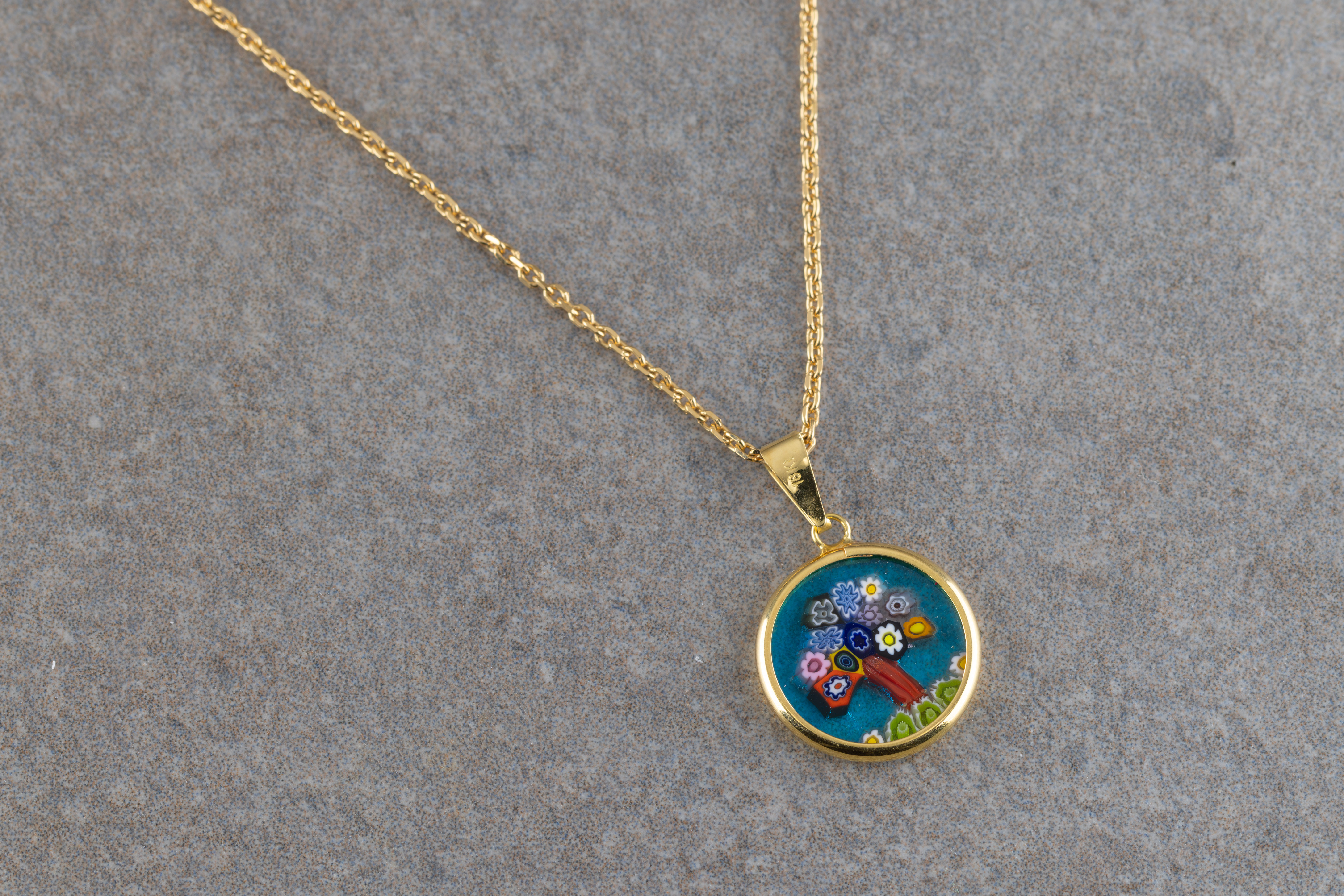 An 18ct yellow gold pendant necklace, the circular coloured glass pendant