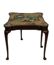 A George I style fold over card table with needlework surface,