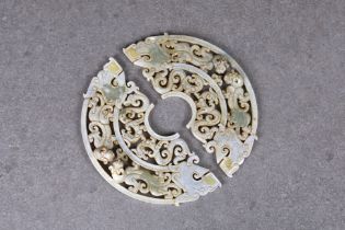 A pair of Chinese celadon jade dragon disc pendants