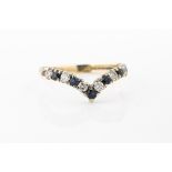 A yellow gold sapphire and diamond "V" shaped ring