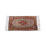 A small Kashan style silk rug