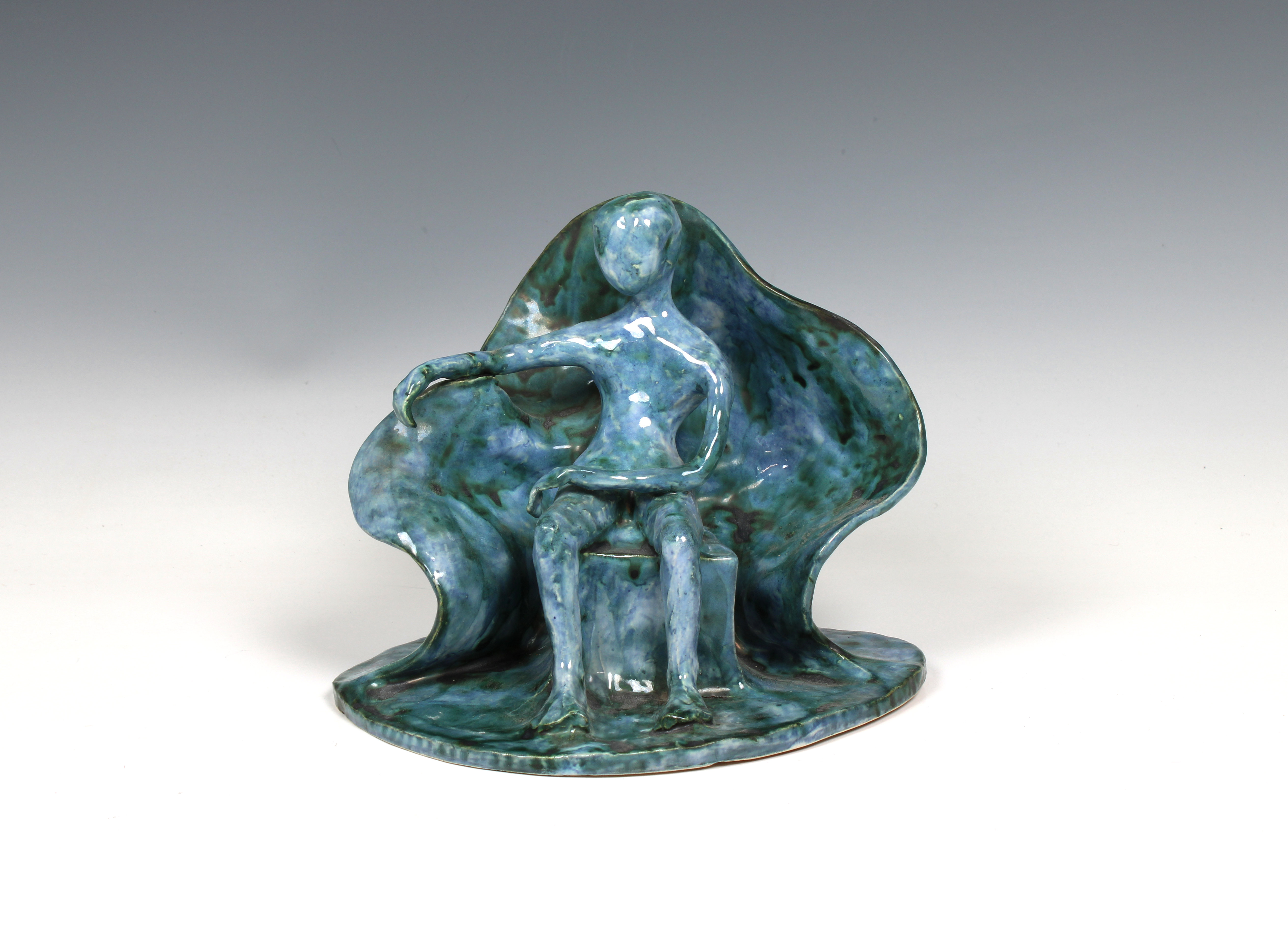 Elizabeth Ann Macphail (1939-89) A turquoise glazed stylised seated figure sculpture