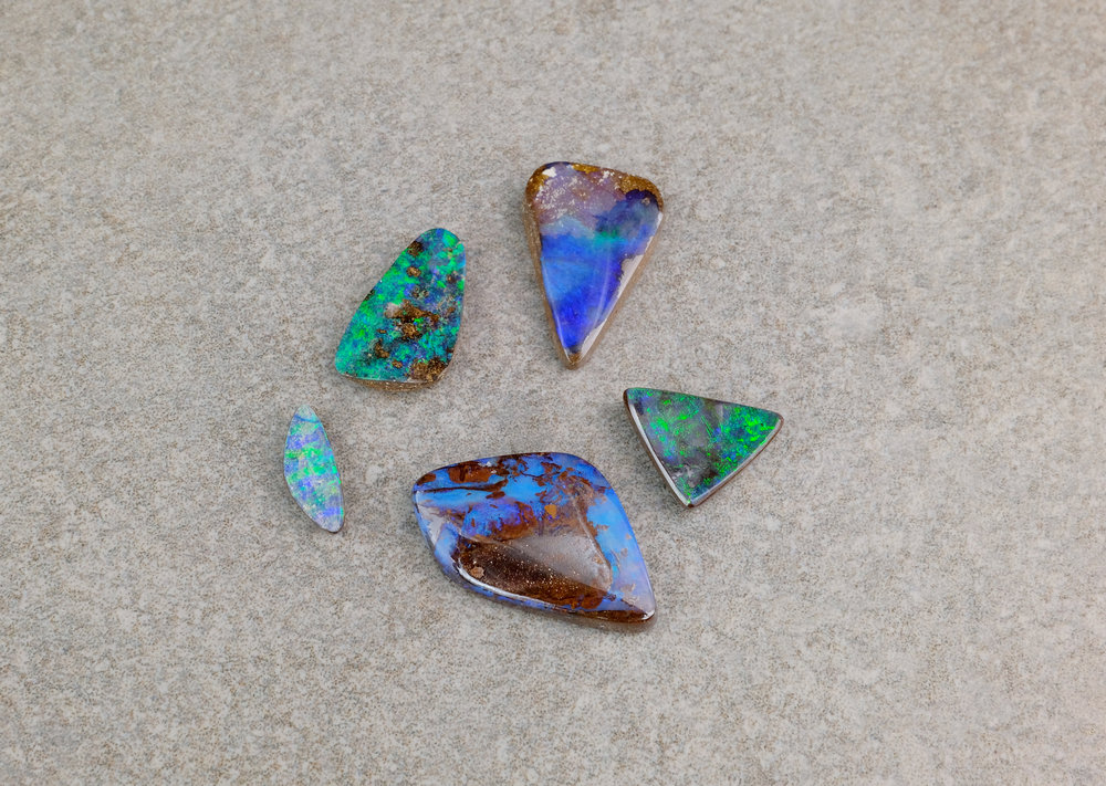 A collection of loose boulder opals