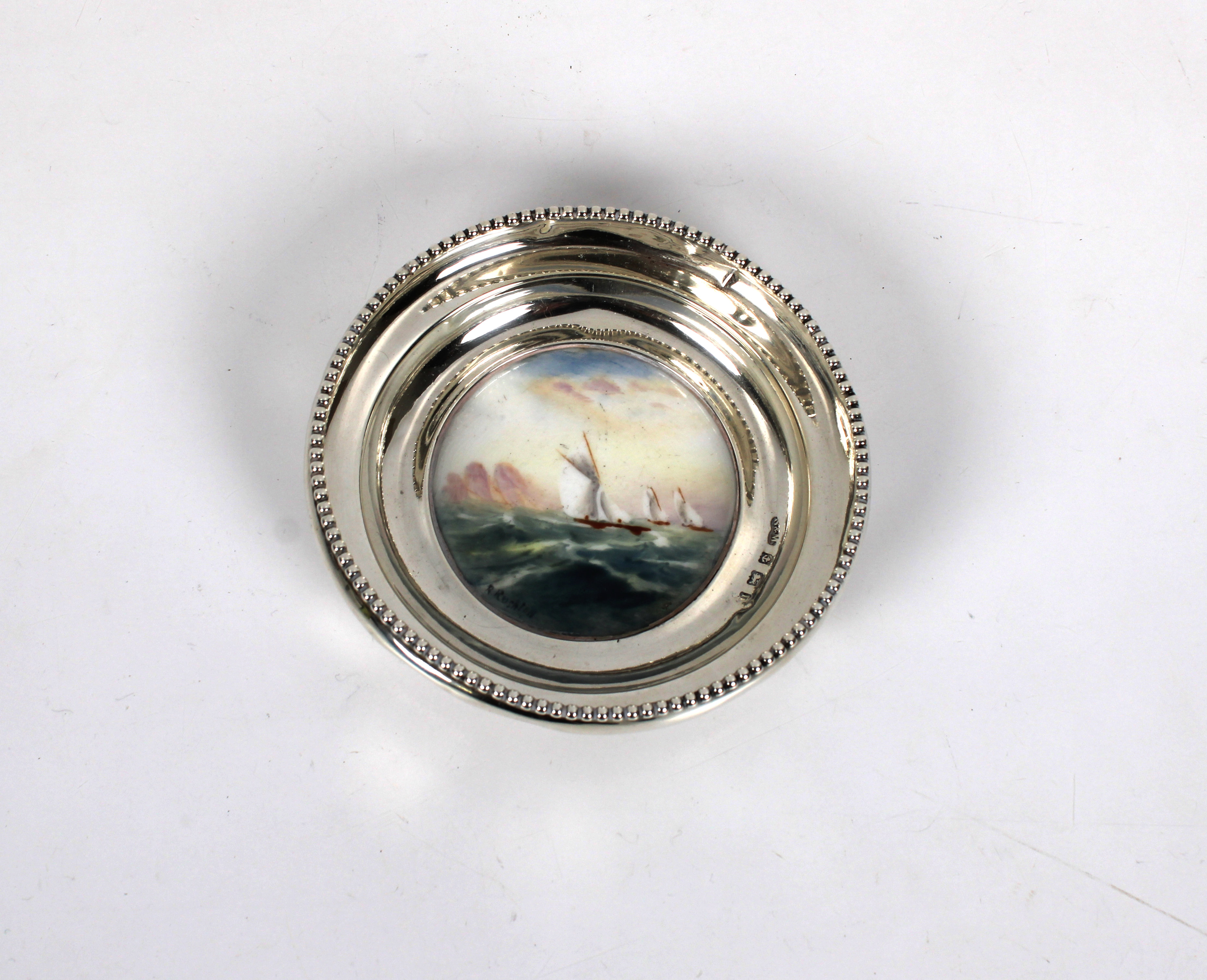 A silver dish incorporating a Royal Worcester porcelain circular plaque