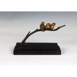 A bronze figure group of three song birds on a branch