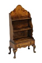 A 1930's burr walnut waterfall bookcase on stand