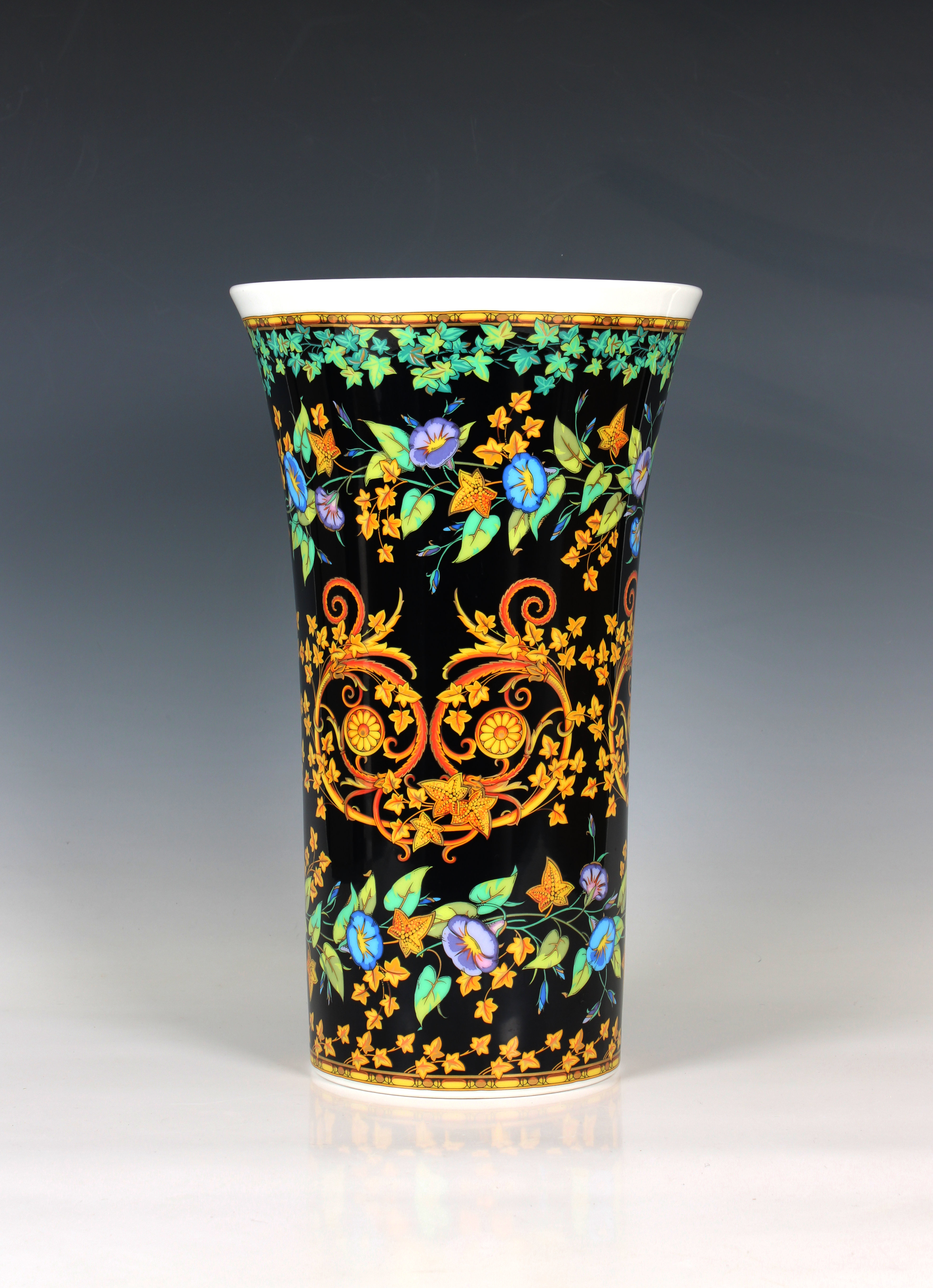 A Rosenthal Versace 'Gold Ivy' cylindrical flared vase, foliate design with gilded highlights