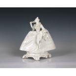 A Nymphenburg white porcelain figure of a lady with a fan