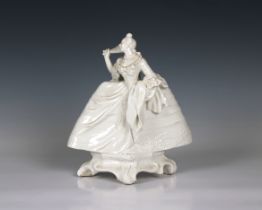 A Nymphenburg white porcelain figure of a lady with a fan