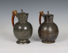 A near pair of antique pewter jugs