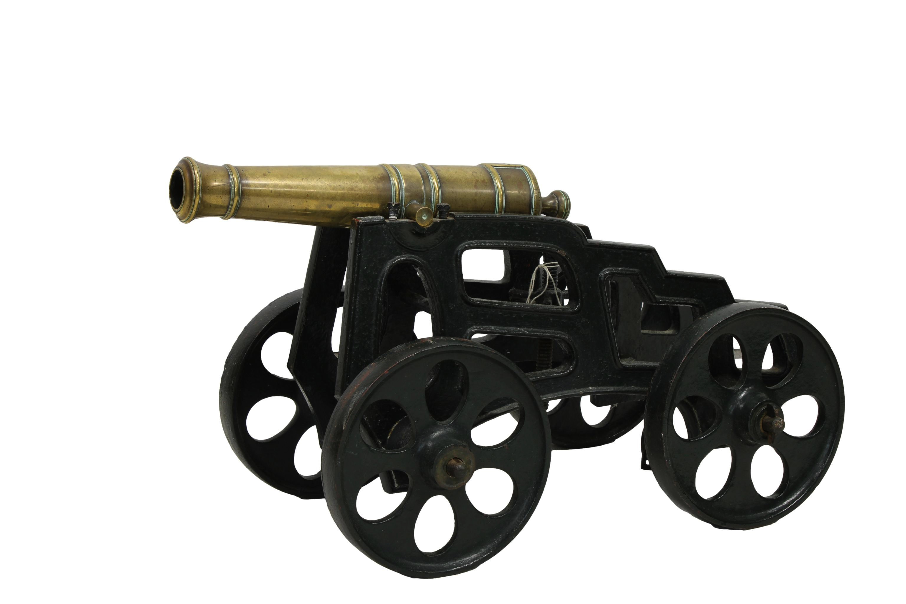 A model cannon with a polished brass barrel and iron four wheeled gun carriage