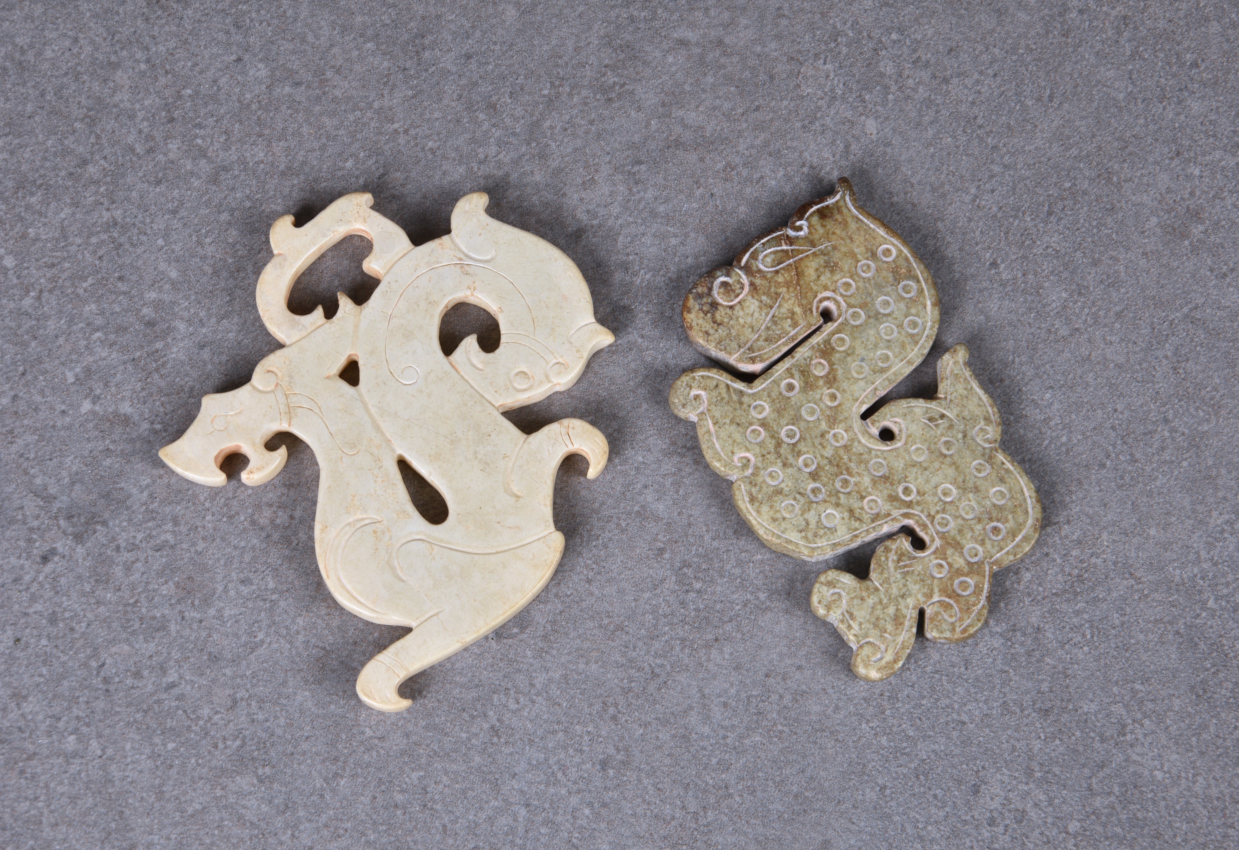 A Chinese Warring States style opaque jade dragon pendant and a Han style jade dragon pendant (2)