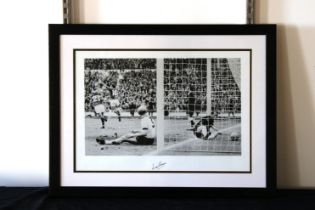 1966 World Cup interest - A signed black & whited photograph print of Martin Peters scoring in the W